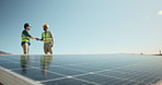 Engineer, team and outdoor with handshake for solar panel, installation agreement and partnership. People, shaking hands and rooftop with photovoltaic system for renewable energy with compliance deal