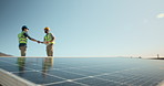 Engineer, talk or outdoor with handshake for solar panel, installation deal and partnership. Men, shaking hands or space with photovoltaic system for renewable energy, compliance agreement or meeting