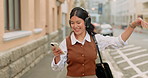 Headphones, dancing and businesswoman with phone in city for listening to music, radio or album. Happy, cellphone and corporate employee with audio tech for streaming playlist in town for commuting.