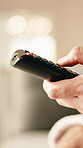 TV remote, choice and hand of person in home for volume, media selection or change channel. People, tech and click on control for entertainment, browsing subscription service and movie in living room