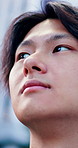 Thinking, Japanese man and city with travel, sightseeing and nostalgia for remembrance. Wonder, inspiration and low angle of Asian person with decision, tourism choice or memory in urban town