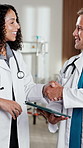 Doctors, people and conversation with tablet in clinic for research, digital app or test results. Man, woman and medical service in hospital with tech, decision and healthcare schedule discussion