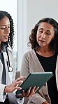 Doctor, tablet and mature patient with discussion for medical service, consulting and help in clinic. Healthcare, telehealth and woman with person on tech for diagnosis results or insurance report