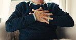 Elderly, man and hands in retirement home with chest pain, acid reflux symptoms and medical problem. Uncomfortable, senior person and heartburn in living room with indigestion, illness and disease.