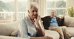 Argument, upset and senior woman on sofa in home with fighting, disagreement or divorce on weekend. Stress, couple and elderly person in living room with marriage fail, breakup or conflict in house.