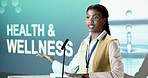 Woman, speaking or presentation in seminar with projector, health and wellness trade show for advice. Black person, talk and proposal in conference for healthcare, medical innovation and research.
