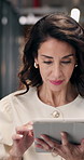 Woman, walk and scroll in office with tablet, check work schedule and email notification in morning. Mature person, browse or planning in hallway with tech, online calendar or business communication.