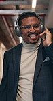 Happy, businessman and greeting with headphones for music, positive energy and good mood in office. Excited, person and walk in wokrplace with audio tech, dance and point at colleagues with smile.