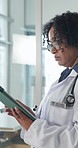 Tablet, doctor and woman walking in clinic for medical update, assessment report or feedback. Serious, healthcare worker and mature person with technology for insurance info, research or telehealth