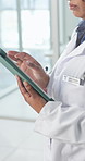 Tablet, doctor and hands in clinic for medical update, telehealth or scroll email while walking. Woman, healthcare worker and technology for insurance information, research and assessment report