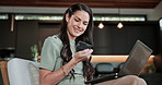 Laptop, debit card and woman in home for online shopping,  typing security code and payment. Smile, computer and person in living room with credit purchase, digital money and ecommerce transaction