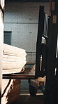 Forklift, warehouse or shipping with wood for cargo distribution, industrial logistics or transport. Vehicle, machinery or lifting with lumber boards for carpentry material or supply chain in depot
