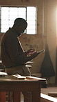 Carpenter, happy and black man on tablet in workshop for planning, report and production schedule. Carpentry, supervisor and person on tech for timber business, woodworking and inventory checklist
