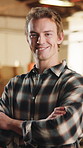 Crossed arms, man and face of carpenter in workshop with confidence for furniture manufacturing. Happy, about us and portrait of woodworker with pride for timber or lumber production in factory.
