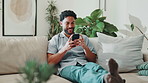 Happy, man and typing with phone on sofa for social media, reading blog or online dating service. Networking, email and subscription with person in living room of home for website, sign up and relax