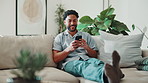 Smile, typing and man with phone on sofa for social media, reading blog or online dating service. Networking, email and subscription with person in living room of home for website, sign up and relax