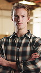 Crossed arms, man and face of woodworker in workshop with confidence for furniture manufacturing. serious, about us and portrait of carpenter with pride for timber or lumber production in factory.