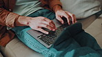 Hands, typing and laptop with man on sofa for social media, reading blog and streaming service. Networking, email and search with male person in living room of home for website, sign up and relax