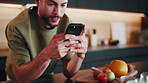 Texting, online and man with phone in kitchen, smile and communication with contact on social media. Typing, message and happy person with mobile, networking and chat with internet connection in home