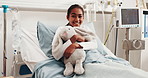 Face, child and bed at hospital with smile, admission and inpatient care for medical treatment. Portrait, girl and happy in ward with teddy bear, patient healing and healthcare services for wellness