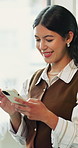 Happy, woman and typing in office with phone, social media marketing and reading comment on campaign. Creative, person and scroll in business with tech, digital advertising and good news for project.
