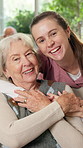Happy, caregiver and face of senior woman in home for bonding, assisted living and medical service. Smile, portrait and nurse with elderly person embrace on sofa for support, healthcare and wellness