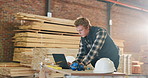 Man, carpenter or laptop in warehouse for wood production, furniture design or construction. Male person, carpentry or computer with timber distribution for lumber project or supply chain in workshop