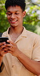 Smile, man and student in nature with phone, chat and scholarship update for education. Happy, male person and walking outdoor with mobile app, study schedule and university application for learning
