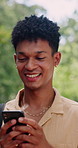 Happy, man and student in nature with phone, chat and scholarship update for education. Smile, male person and walking outdoor with mobile app, study schedule and university application for learning