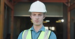Face, confidence and man at factory for manufacturing, ppe and industrial professional with pride. Portrait, production engineer and serious person with safety helmet, quality control or supply chain