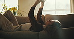 Woman, relax and selfie on couch with phone, typing or upload profile picture for online dating app. Person, rest and photography in house with mobile tech, social media post or text message response