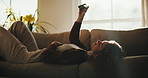 Happy, woman and selfie on couch with phone, typing or upload profile picture for online dating app. Person, relax and photography in home with mobile tech, social media post or text message response