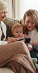 Happy, baby or family with phone on sofa for watching cartoon, nursery rhyme or lullaby video. Child, mother and grandmother with mobile in home for educational app, bonding together and generations