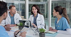 Medical, team or laptop in clinic meeting for case review, clinical protocols or discharge plan. People, doctors and nurses with tech for shift handover, task delegation or notes on care coordination