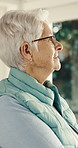 Thinking, smile and old woman at window with nostalgia, daydreaming and flashback with calm mindset. Happy, bokeh and elderly person with reflection, good memory and peaceful perspective in house.