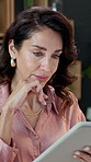 Woman, thinking and research in office with tablet, budget and typing report for project management. Mature person, problem solving and scroll in business with tech, financial planning and schedule.