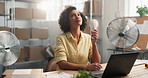 Fans, laptop and logistics with woman in office of warehouse for delivery or distribution management. Air flow, cool down and supply chain with employee in hot workplace for ecommerce shipping