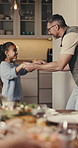 Father, child and dance at family dinner in home with love, teaching moves and bonding together. Holding hands, girl and parent with music, care and spin for learning with happiness at dining room