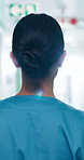 Back, woman and nurse walking at hospital, shift arrival and ward rounds for patient care in lobby. Female person, punctual and medical assistant in hallway, emergency response and healthcare service