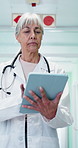 Tablet, woman and doctor in hospital for research on medical diagnosis or treatment planning. Digital technology, walking and mature healthcare worker with telehealth service on app in clinic.
