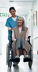 Walking, nurse and senior woman in wheelchair in hospital for support, checkup or medical assistance. Happy, caregiver and elderly person with disability in clinic for consultation, help or discharge