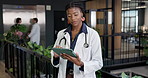Medical, doctor and woman with tablet at clinic lobby, insurance information or case study. Tech, worker and person in hospital for telehealth report, typing schedule or review healthcare history