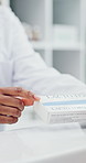 Medication, hands and pharmacist with explanation in pharmacy for side effects or customer. Medicine, discussion and chemist with person for dosage instructions, pill box and dispensary in drug store
