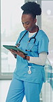 Woman, doctor and review at hospital with tablet, research and notification for medical results. African person, reading or email at clinic with digital, telehealth and update schedule for healthcare