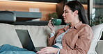 Laptop, movie and woman with coffee on couch, relax and watching series with subscription in lounge. Streaming, online and person with hot beverage, chilling and entertainment with tech in house