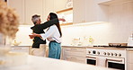 Women, laughing and hug with senior mother in kitchen, excited and listening to good news in house. Family, bonding and happy person with old parent, embrace and celebration for success in home