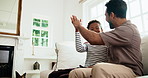Man, child or watching tv with high five in home for celebration, winning or success together. Uncle, male person or excited nephew with smile or fist pump on sofa for victory or achievement in house