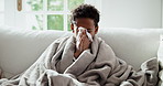 Child, kid and blowing nose with tissue in home for influenza, viral infection or illness. Sick, boy or cold with flu, toilet paper or cough on sofa for virus, hayfever or bad allergies in house