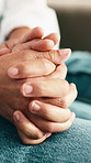 Home, holding hands and couple on couch with support, comfort and care for bonding and marriage. People, man and woman together with relationship, relax or trust with romance and love in living room