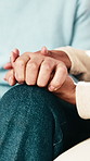 Home, holding hands and couple on couch with comfort, love and care for bonding and marriage. People, man and woman together with relationship, relax or trust with romance and support in living room
